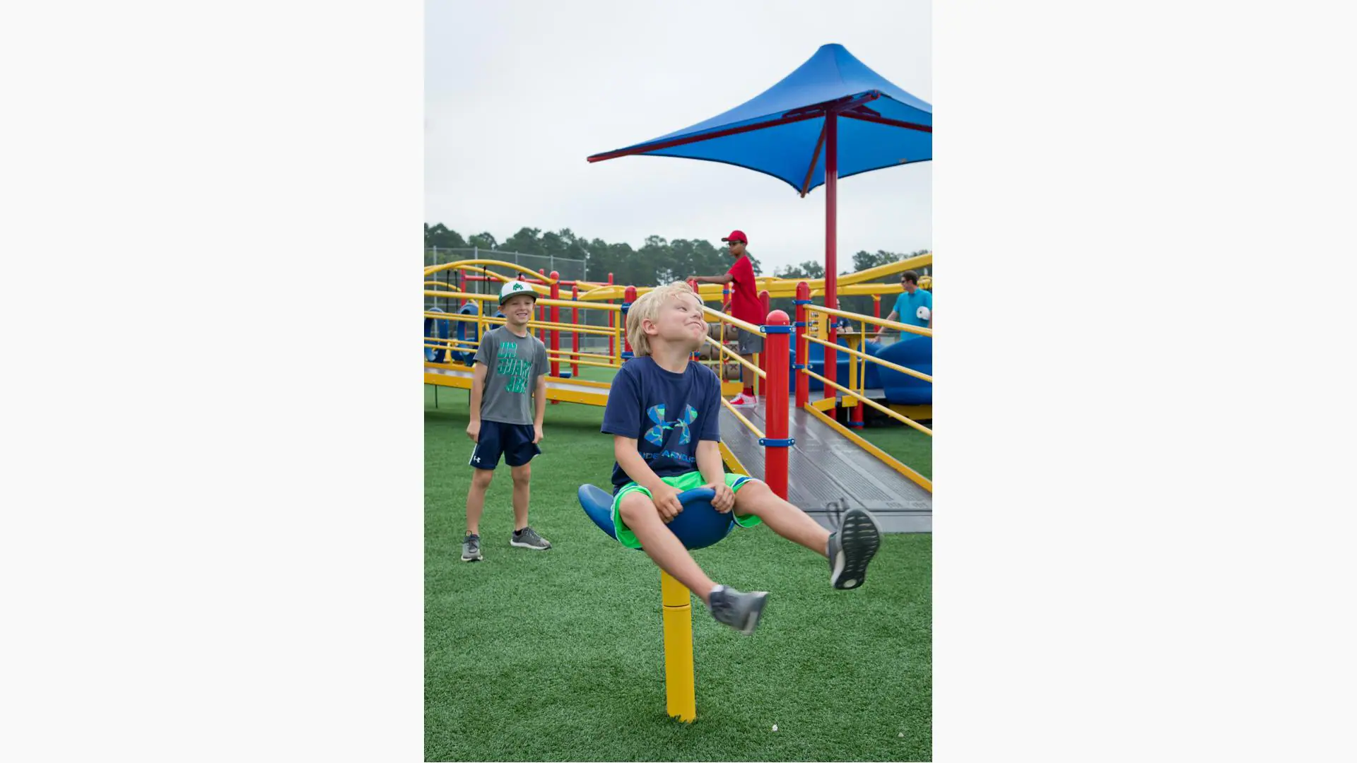 Families using accessible play equipment at Miracle League of Monticello