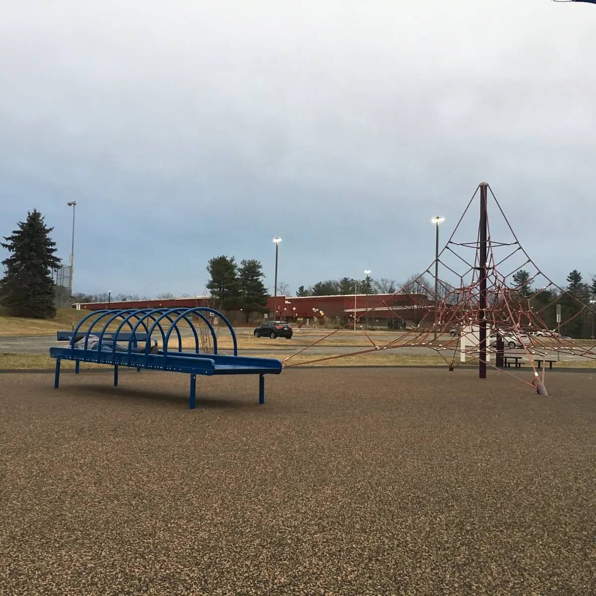 Rope climbing and seating area near parking
