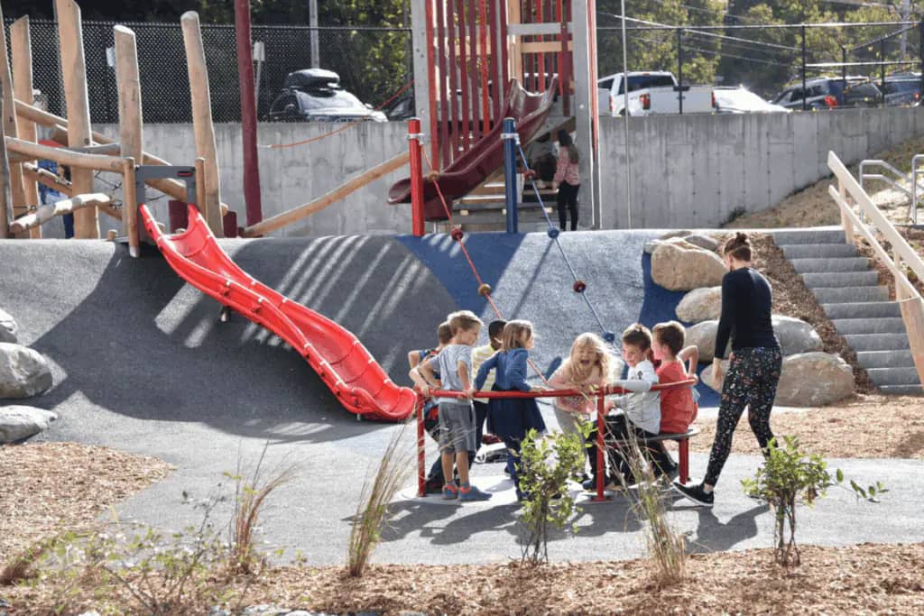 Children using the accessible whirl at the new St. Johnsbury School playground