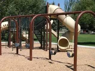 Brown playground structure at Owen Bircher Park in Wilson, Wyoming