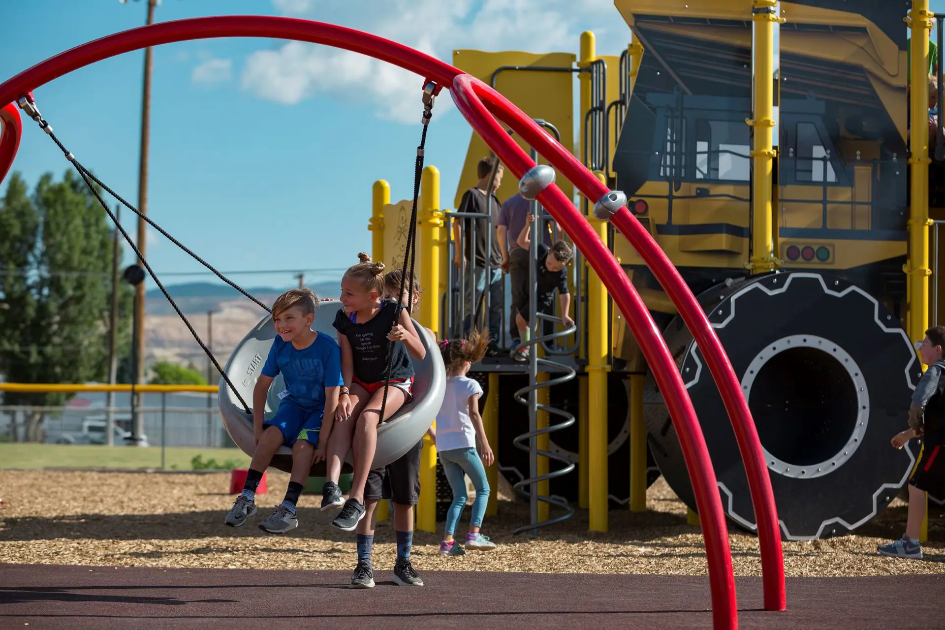 Children playing on the mining-themed inclusive playground at Stodden Park in Butte