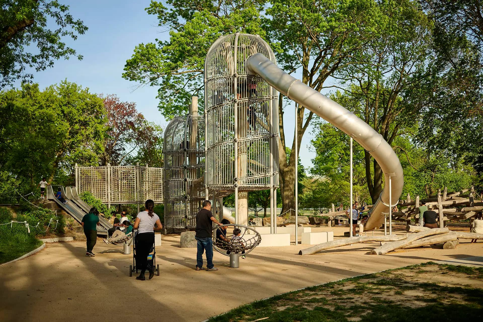 Families using the inclusive play space at Anna C. Verna Playground