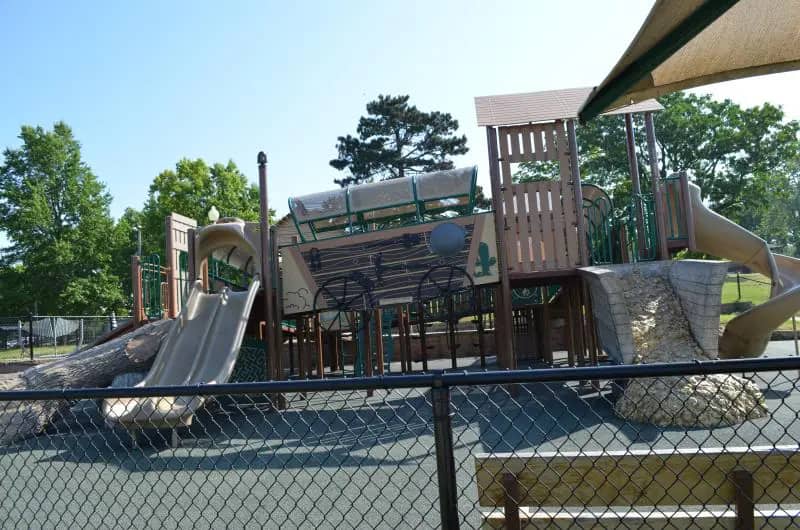 Old west themed fenced playground at McCoy Park