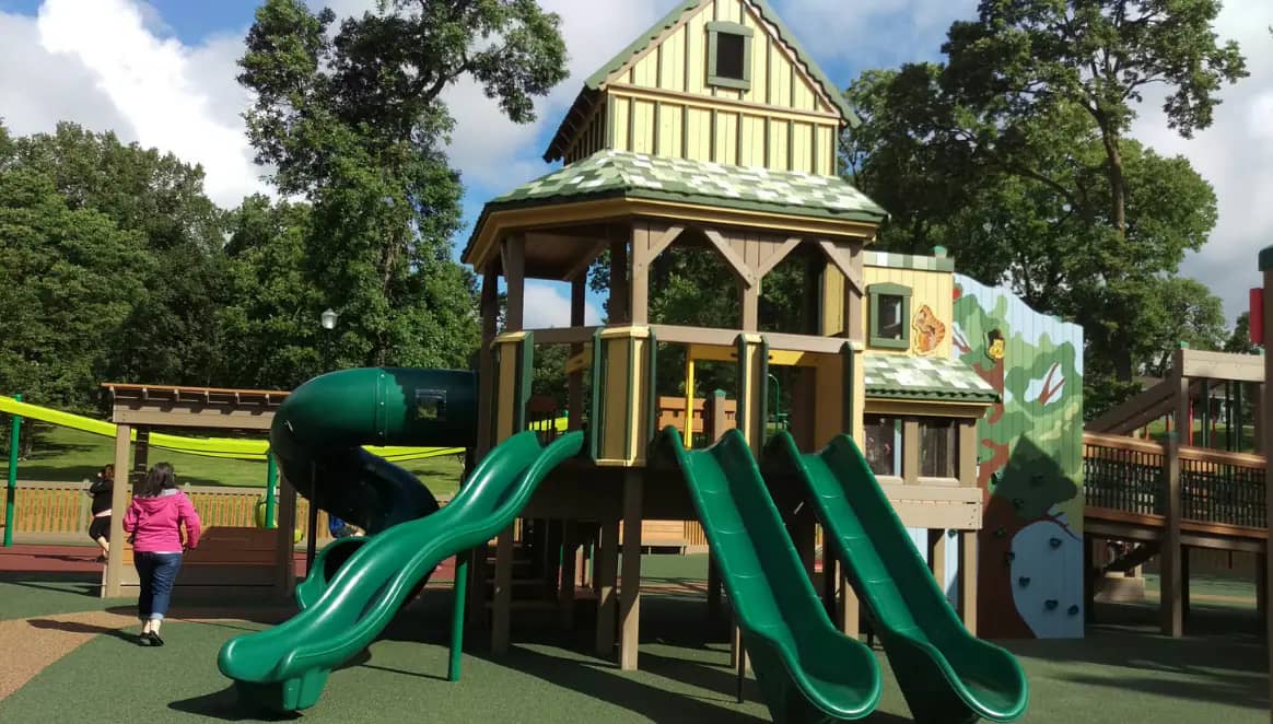 Castle-themed accessible play structure with ramps and slide at Willmar Destination Playground